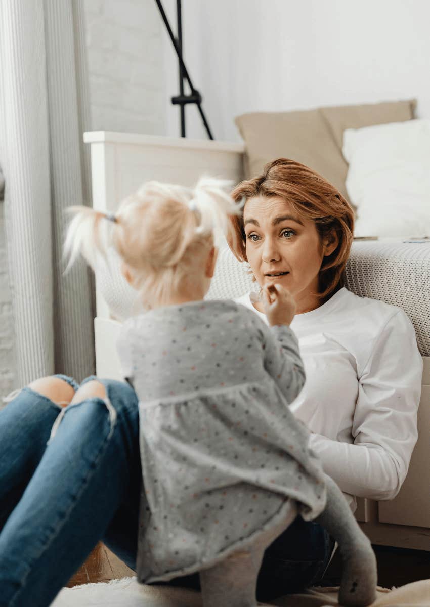 adult parent talking to a small toddler