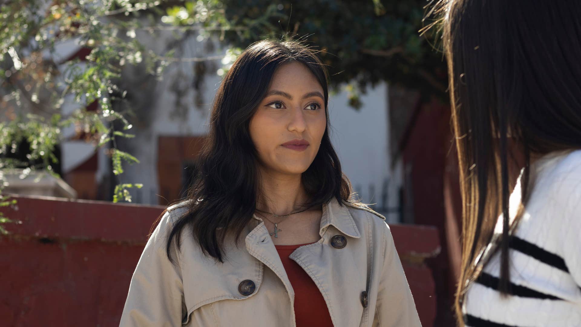woman in brown jacket suddenly feels who is and isn't hers as she stares at her friend