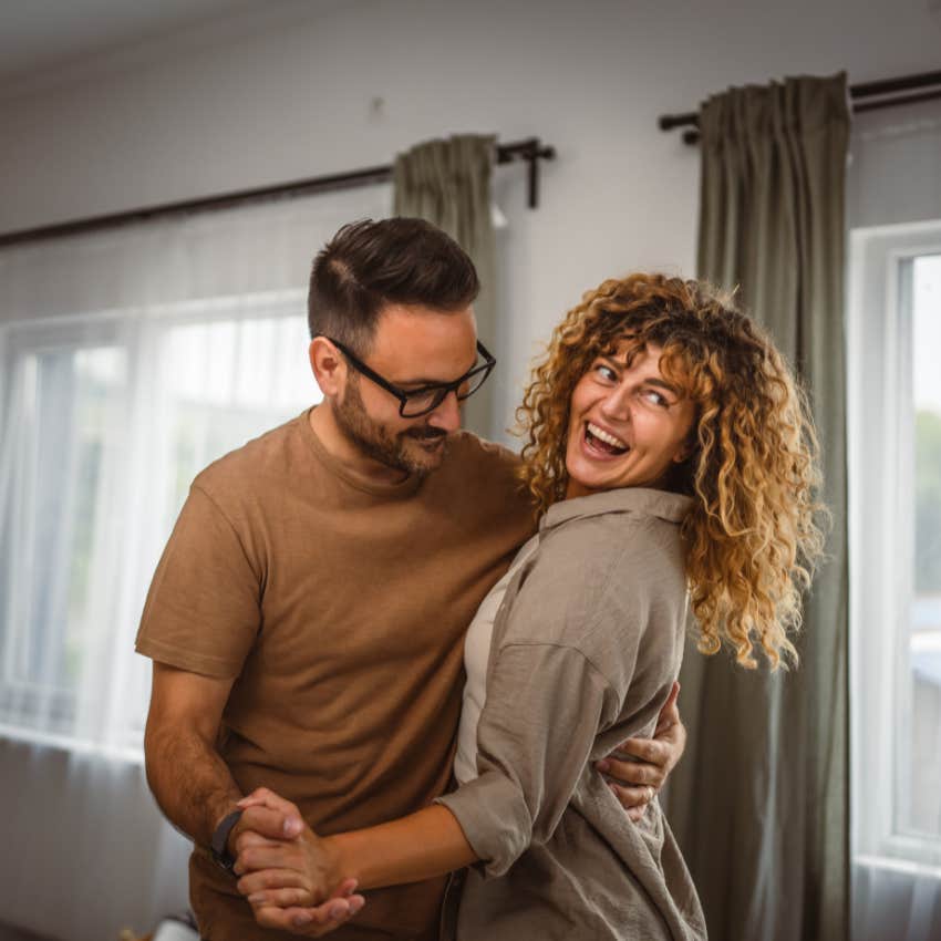 man with natural charm giving woman a compliment from a book