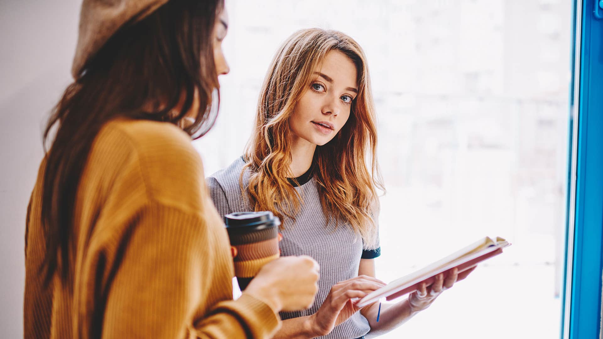 young woman financially peer pressuring her friend