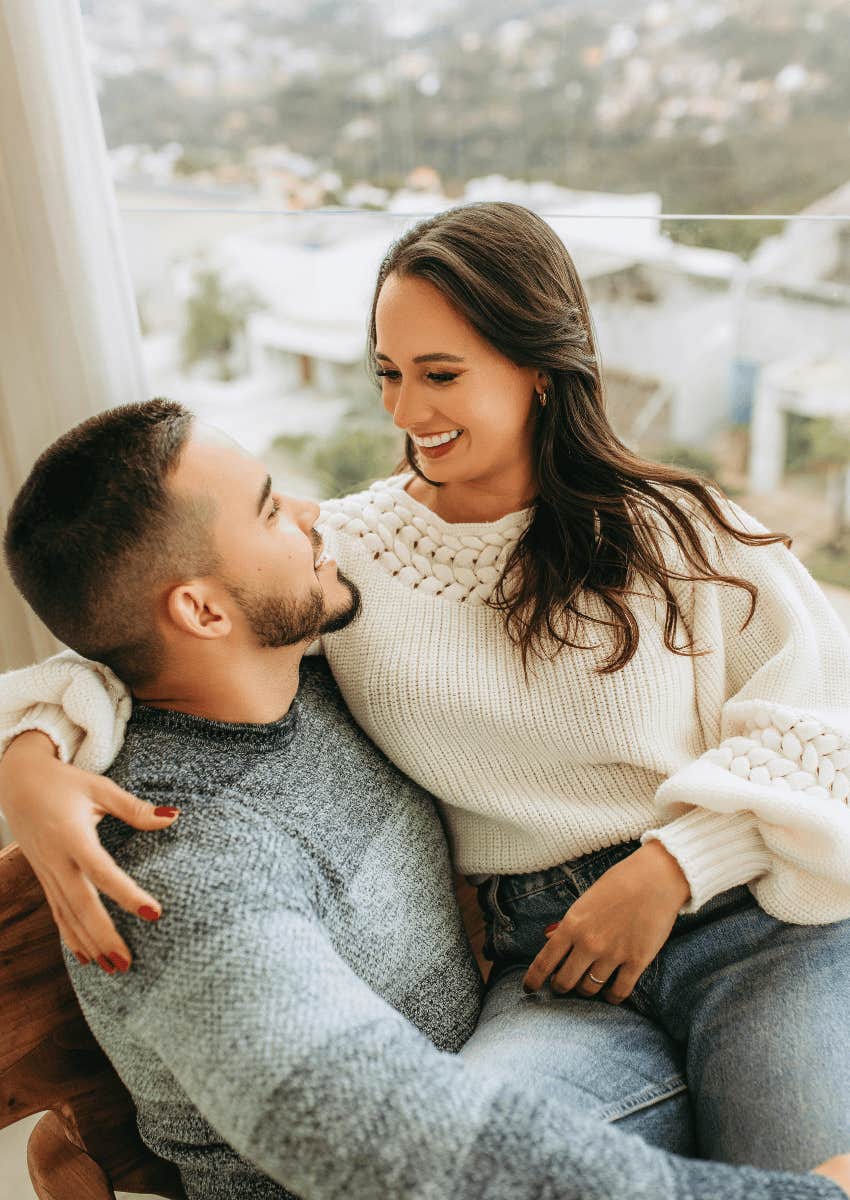 happy woman sitting on a happy man's lap
