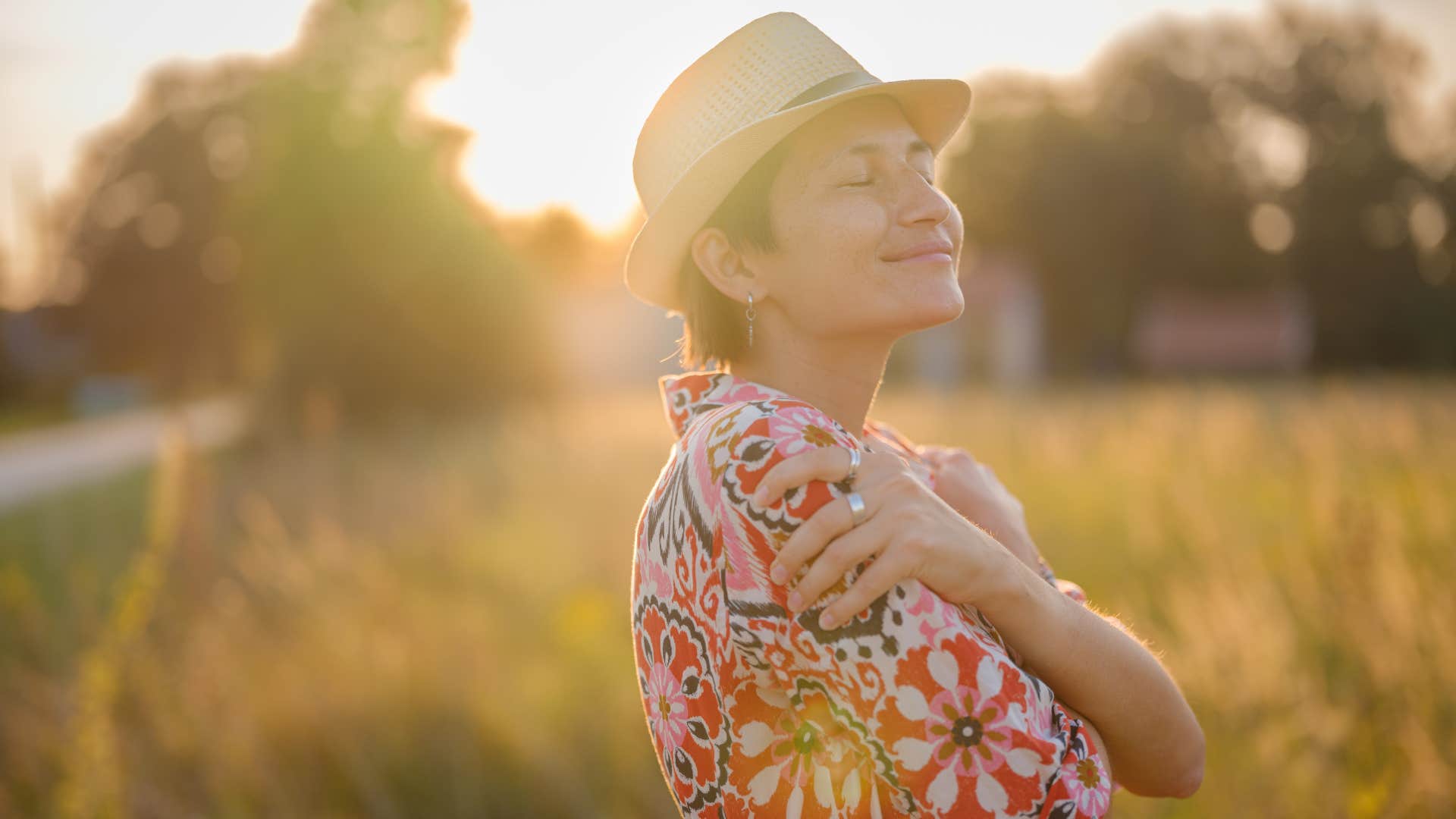 Calm person hugs self showing habit to find good