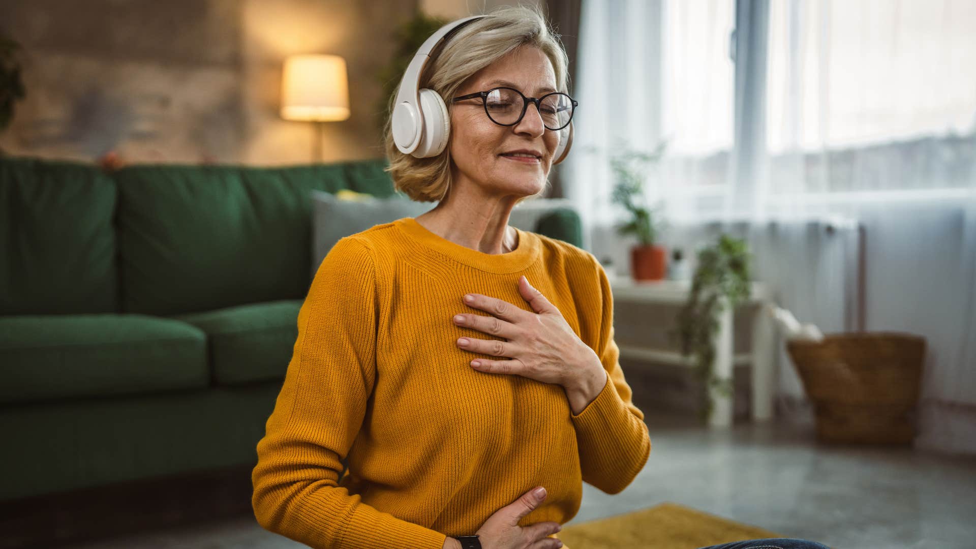 Calm person tocuhes heart and stomach showing habit to soothe