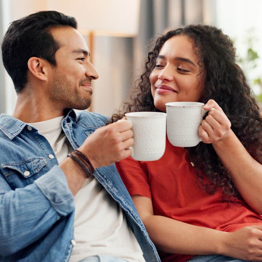 gentlemanly husband who actively listens to his wife sitting drinking coffee