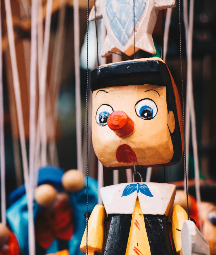 Pinocchio kid's marionette toy hanging by strings