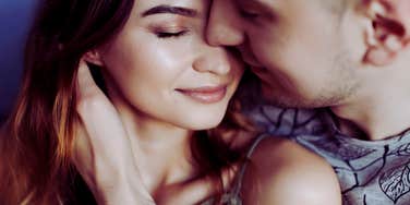 Man using loving phrases to the person he loves while hugging her