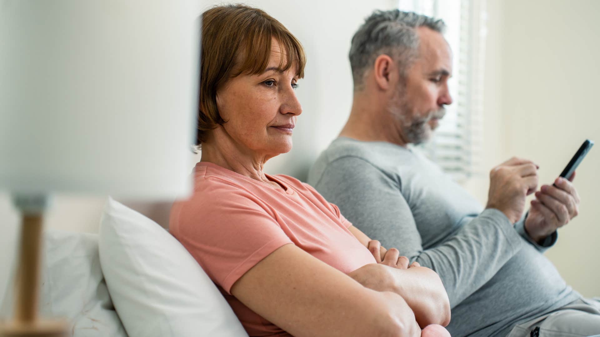 Man who's always on their phone sitting in behind their wife.