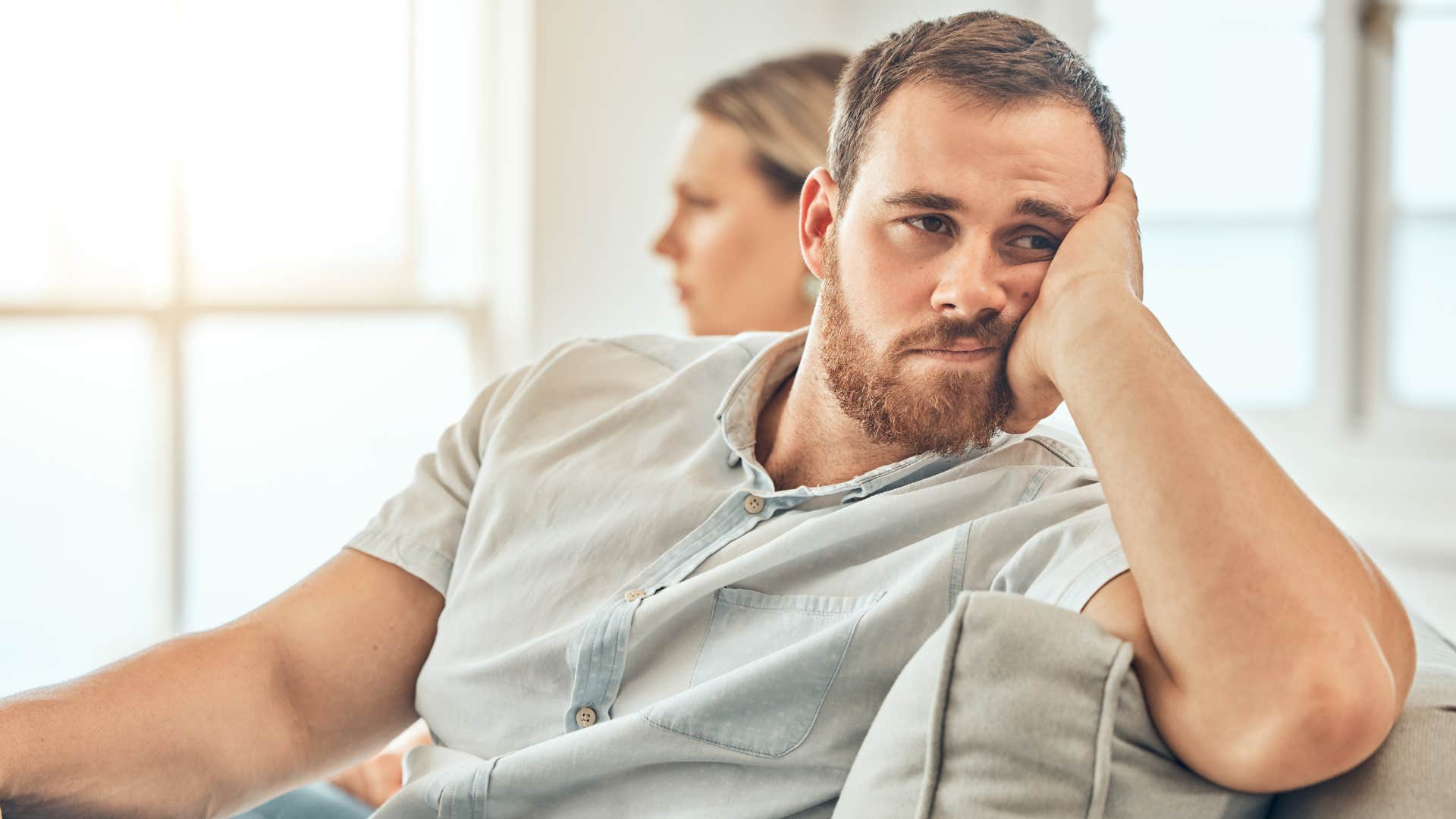 Man who's stopped doing the little things sitting on his couch.