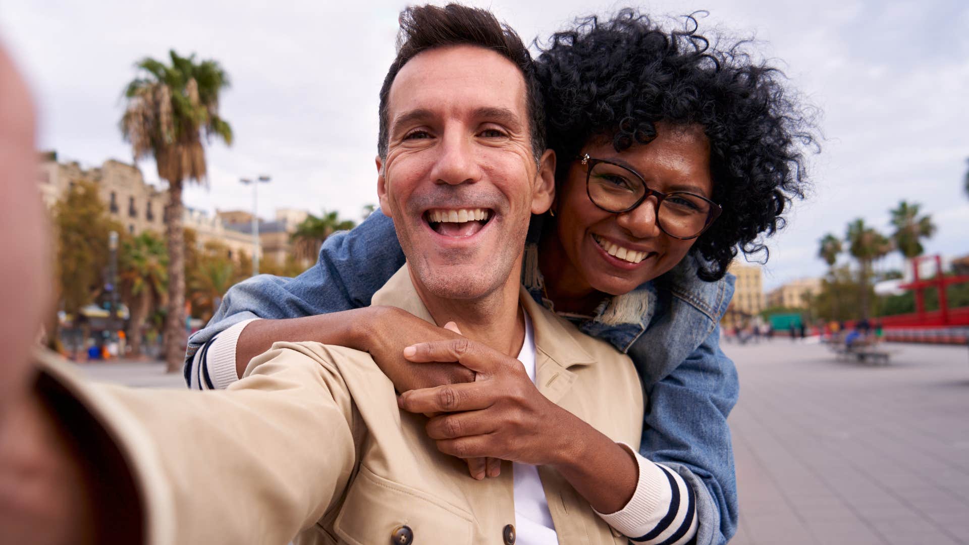 couple whose romance has evolved smiling taking selfie