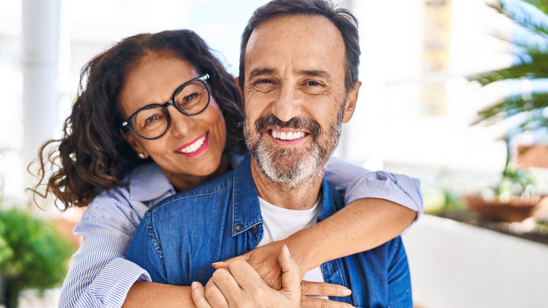 couple with shared history smiling and hugging each other