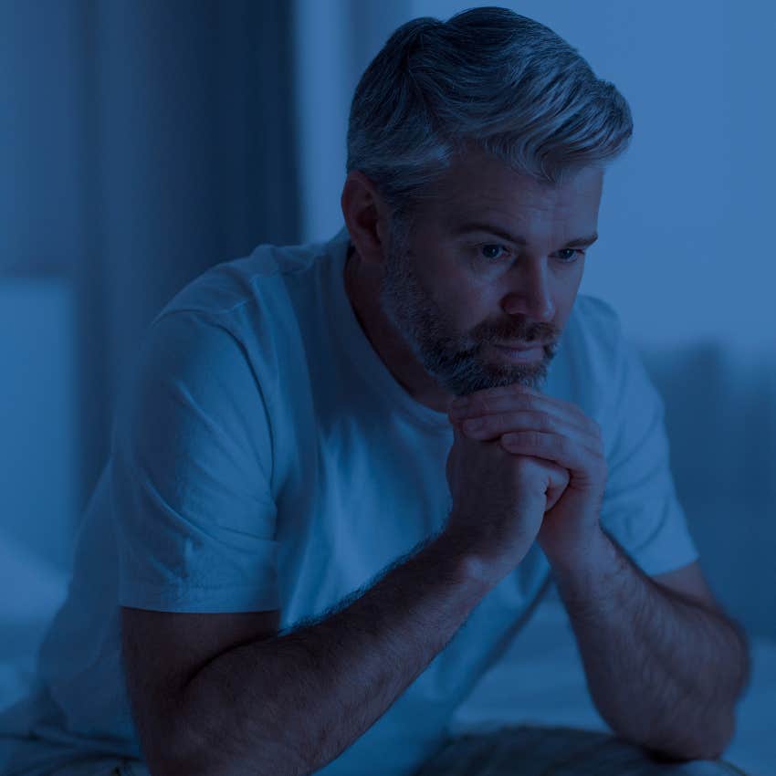 Man feeling disconnected sitting up at night.