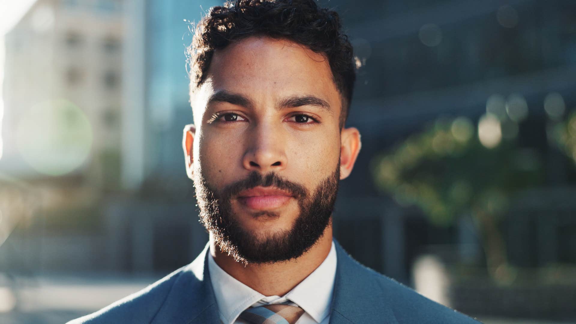 serious businessman standing outside