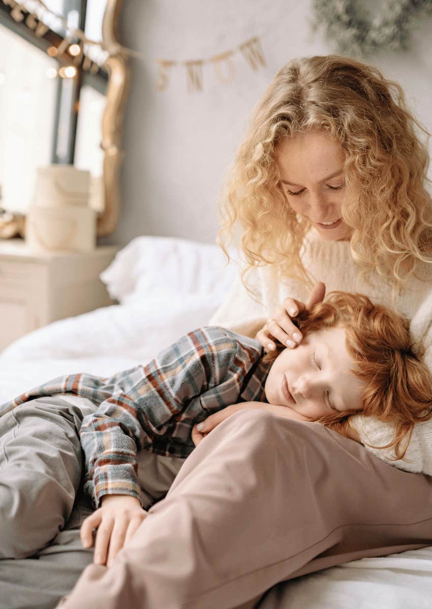 mom softly touching her childs face