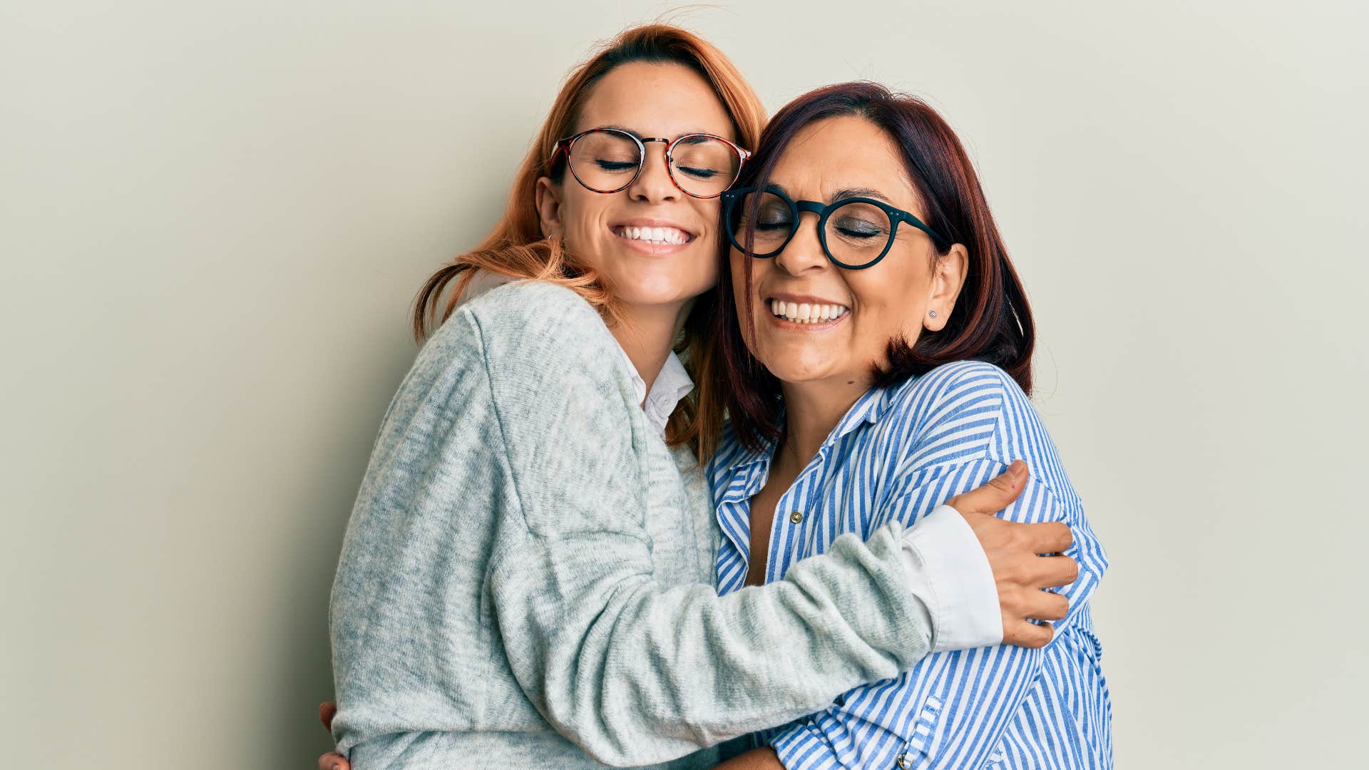 intelligent mother and daughter hugging