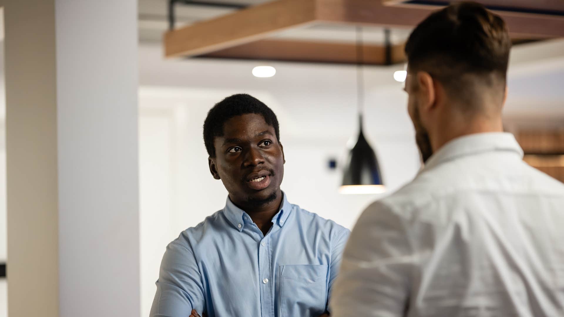 man looking perplexed as coworker gives hot takes