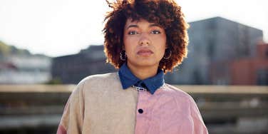 mentally sharp woman looking annoyed standing outside