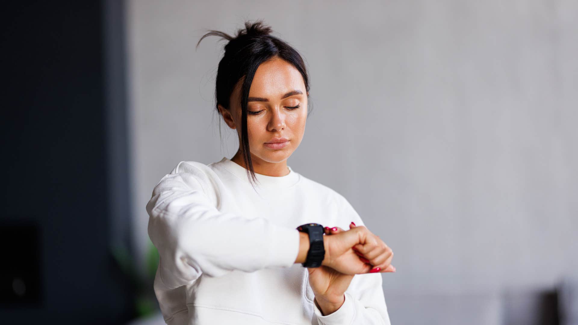 Serious person checks watch and has to go showing way to make life harder