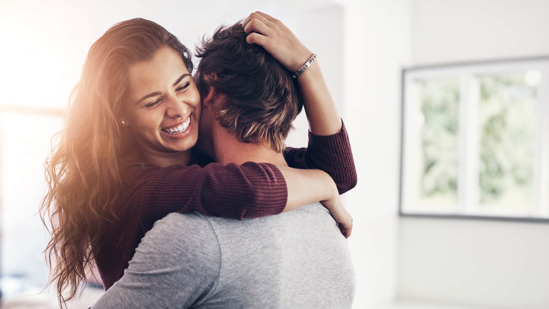 woman hugging man no longer investing her energy where it's not reciprocated