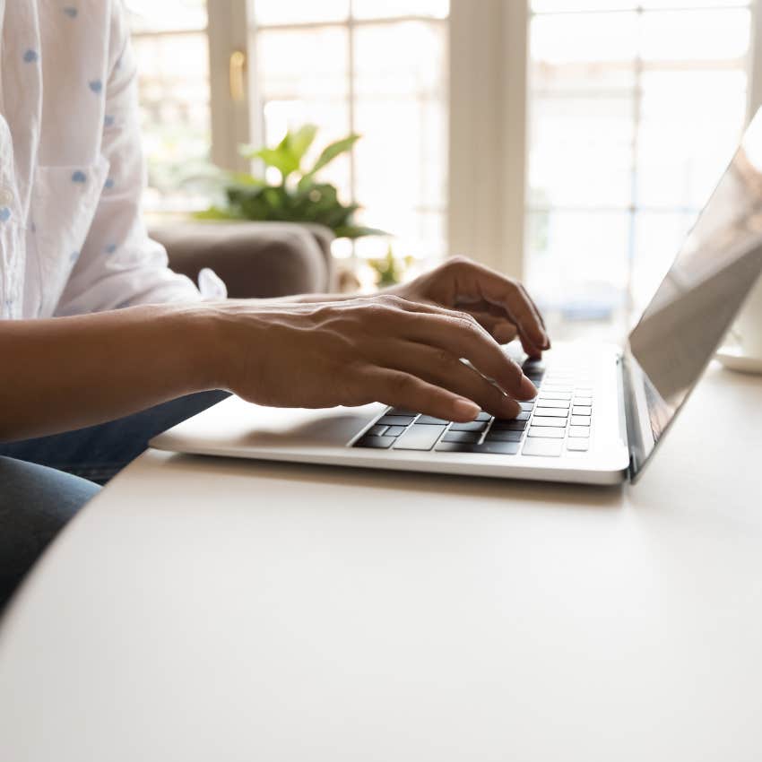person who was born to win typing on laptop