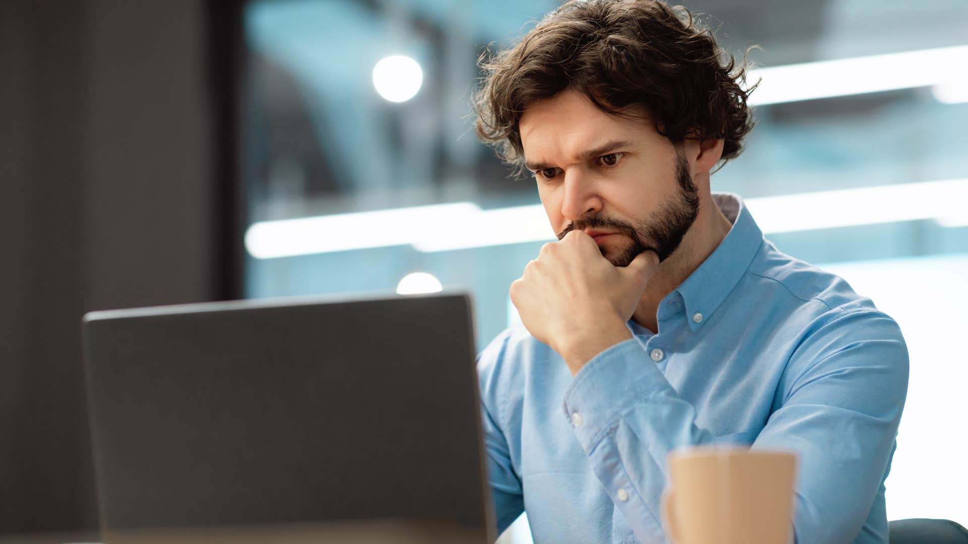 man with a complex mind who appreciates a challenge working on his laptop