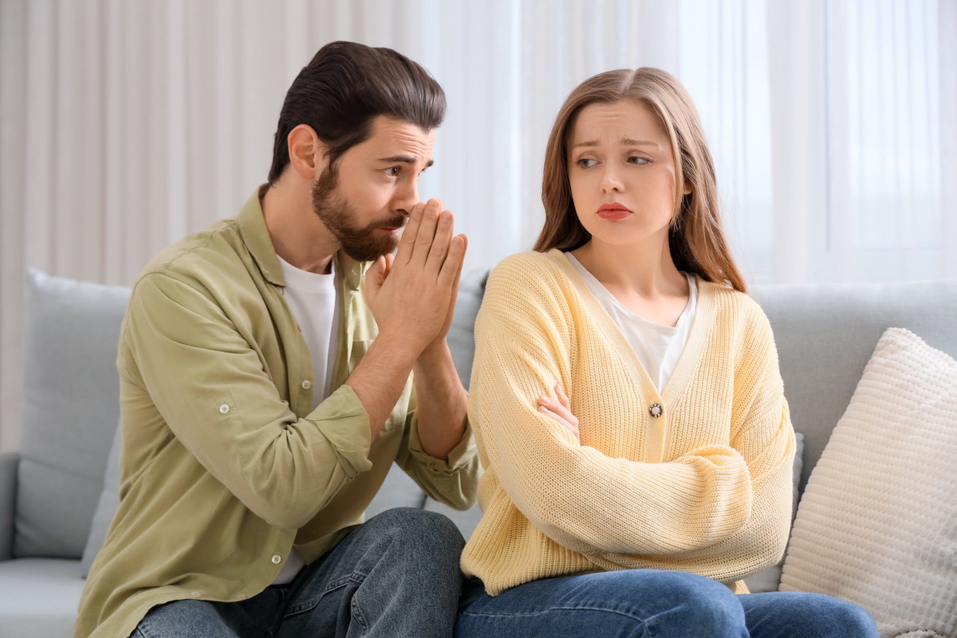 man who forgives himself easily as he apologizes to woman