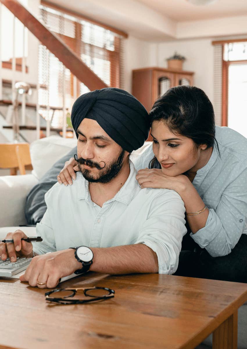 supportive woman looking over her partner's shoulder