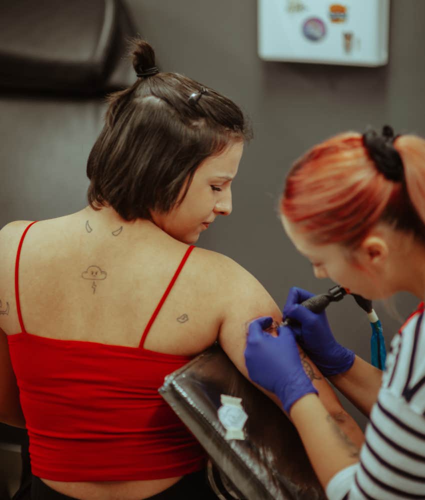 Woman getting tattoo