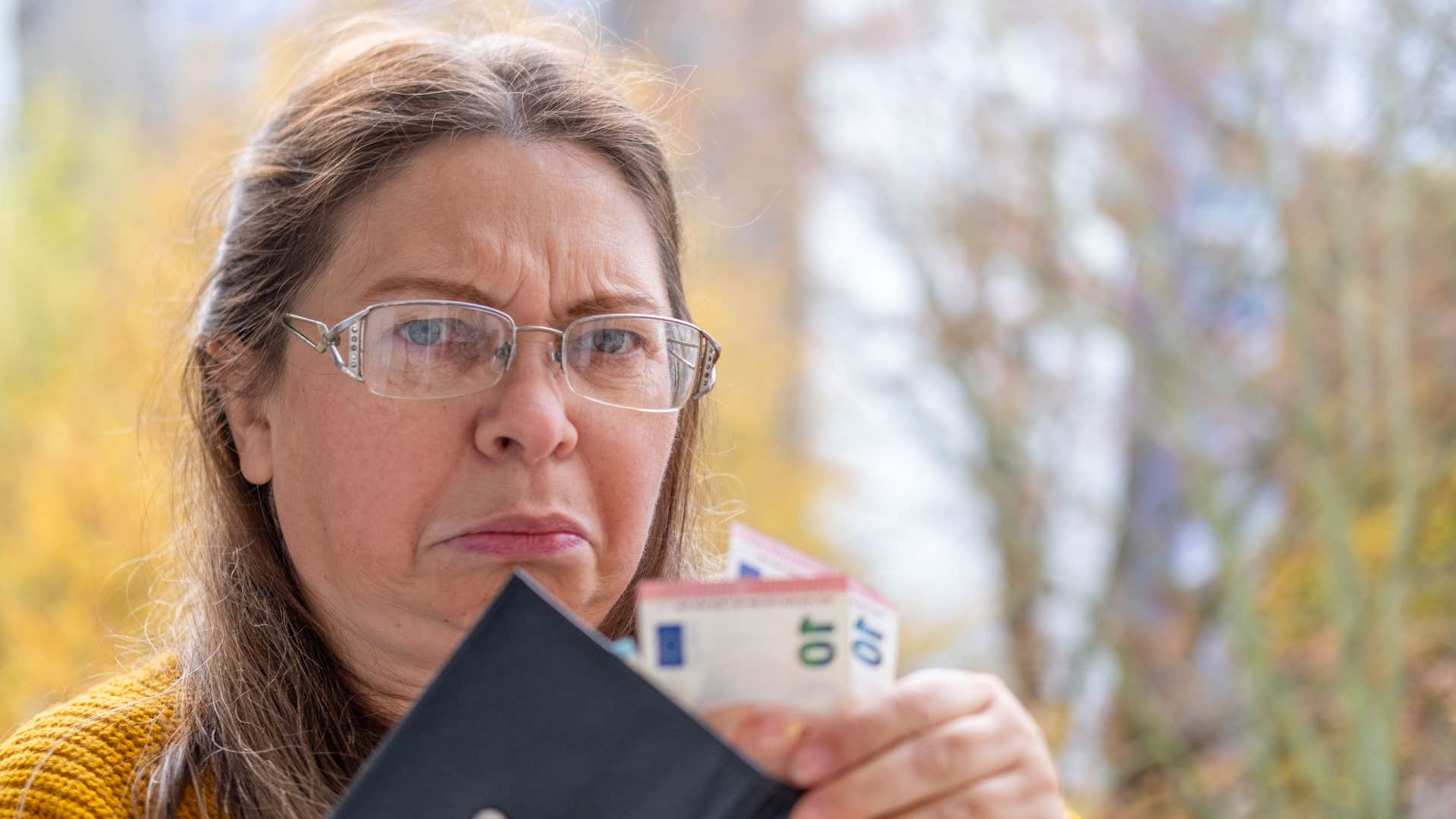woman who is falling behind financially avoiding talking about savings or emergency funds