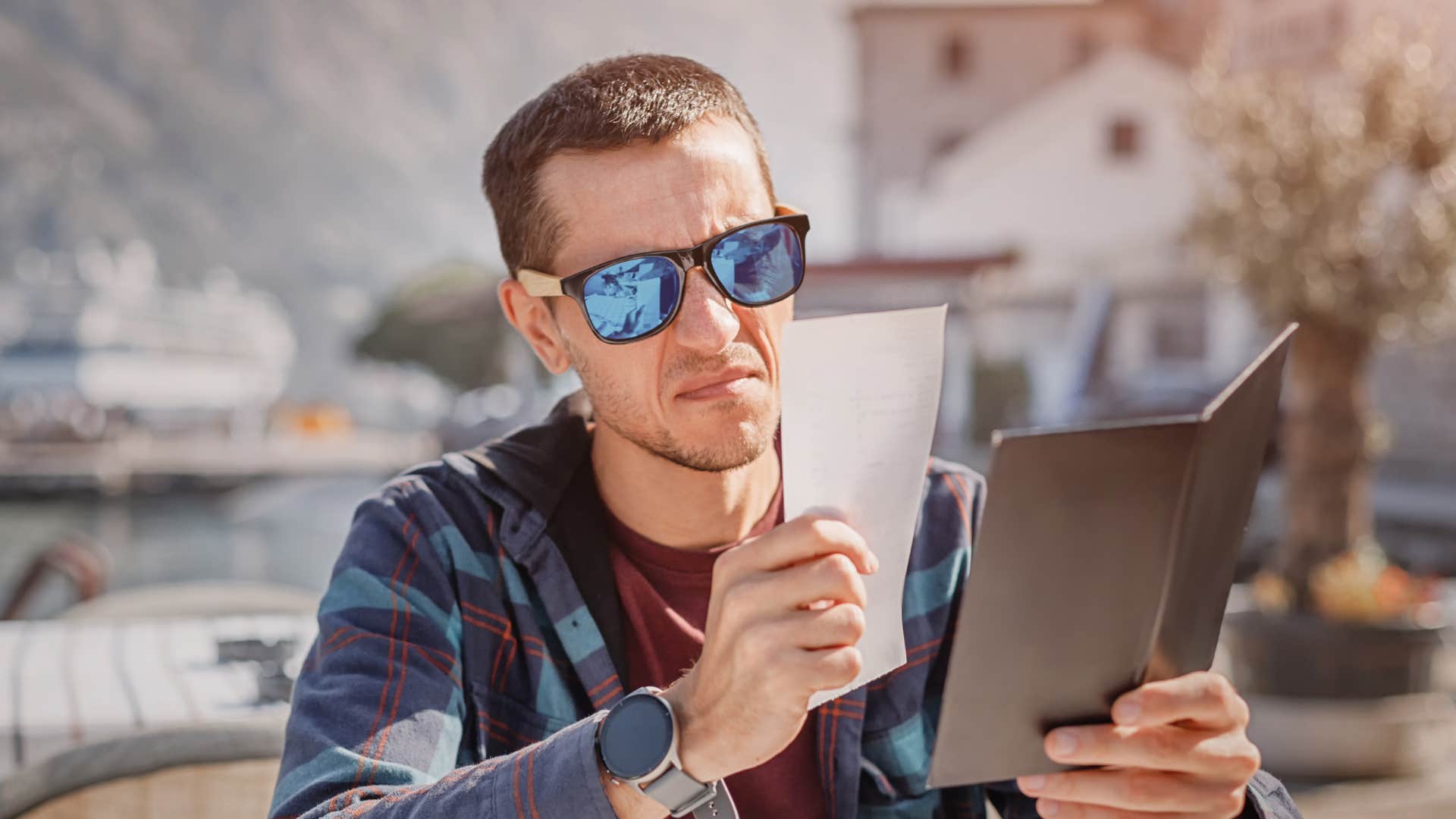 man looking at bill frowning as he treats others like a transaction