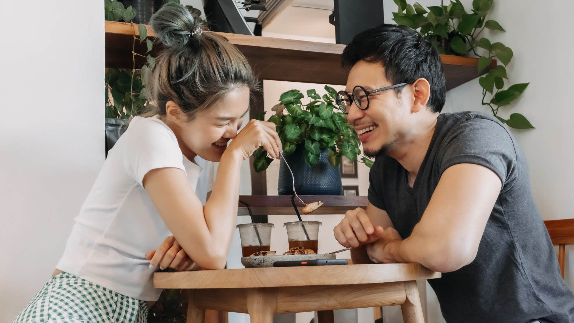 man and woman laughing as they both pay attention and stay off the phone