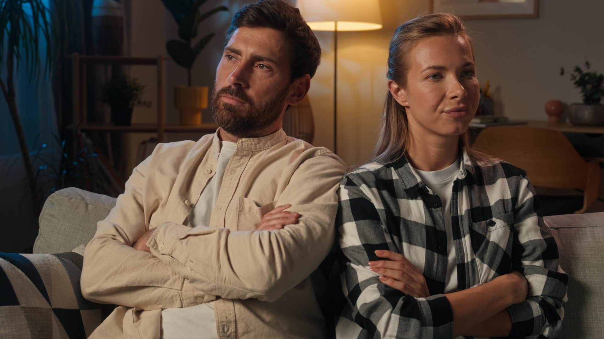 man being silent avoiding wife sitting next to her