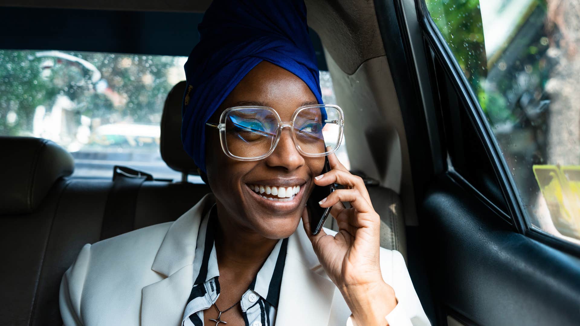 woman booking a trip with a travel agent on the phone