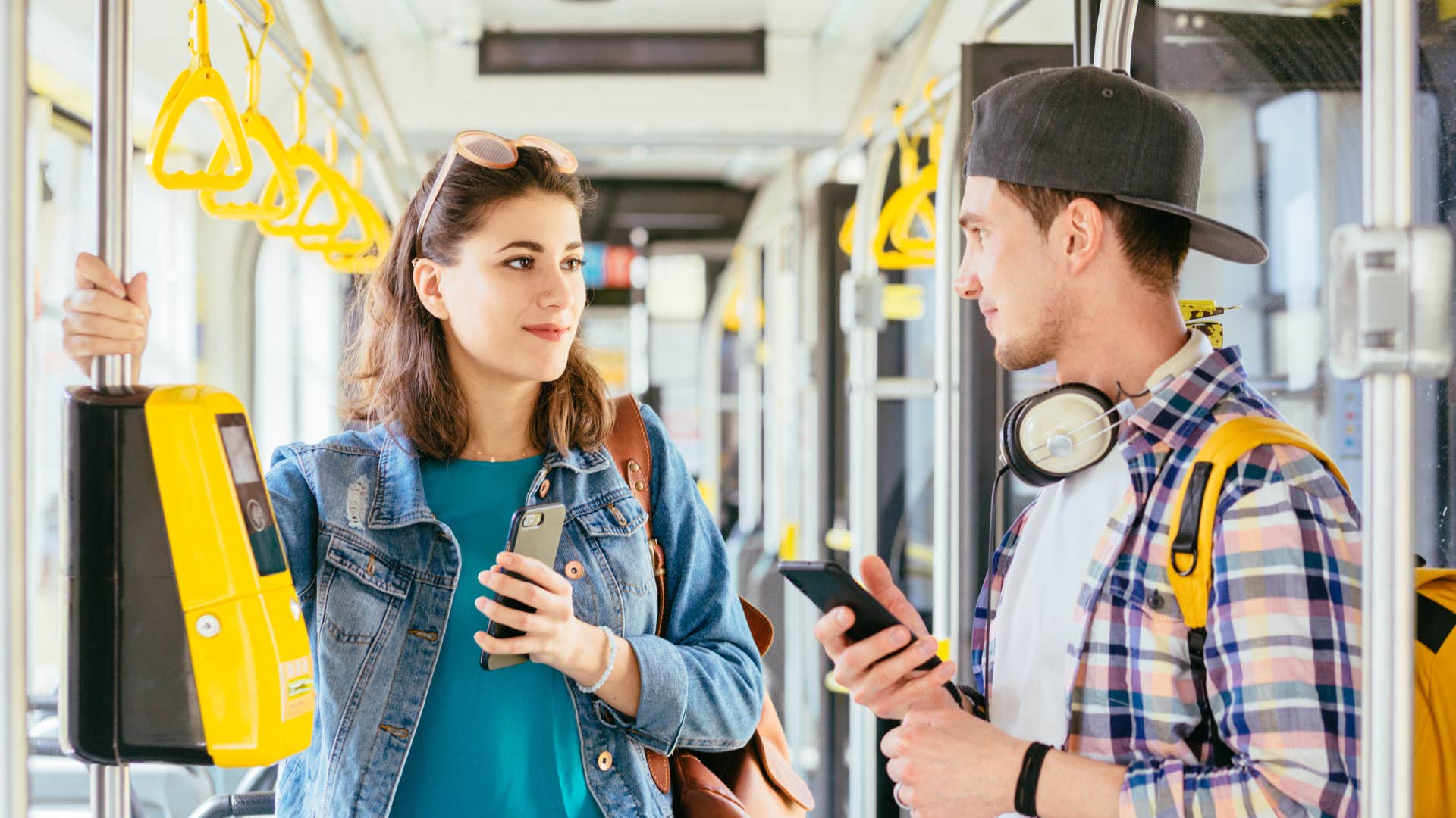 woman riding bus helping fellow traveler