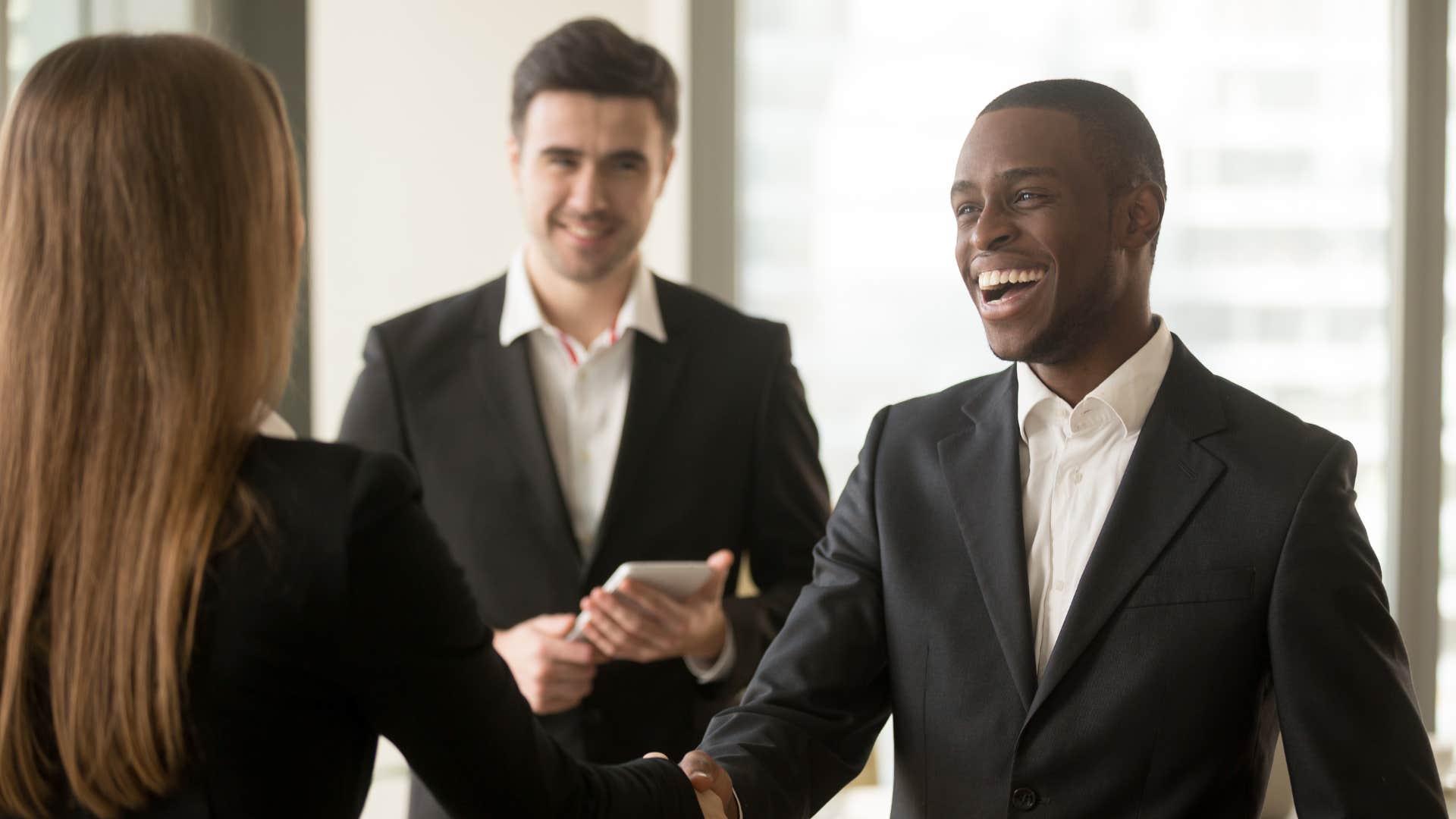 loyal employee shaking boss's hand