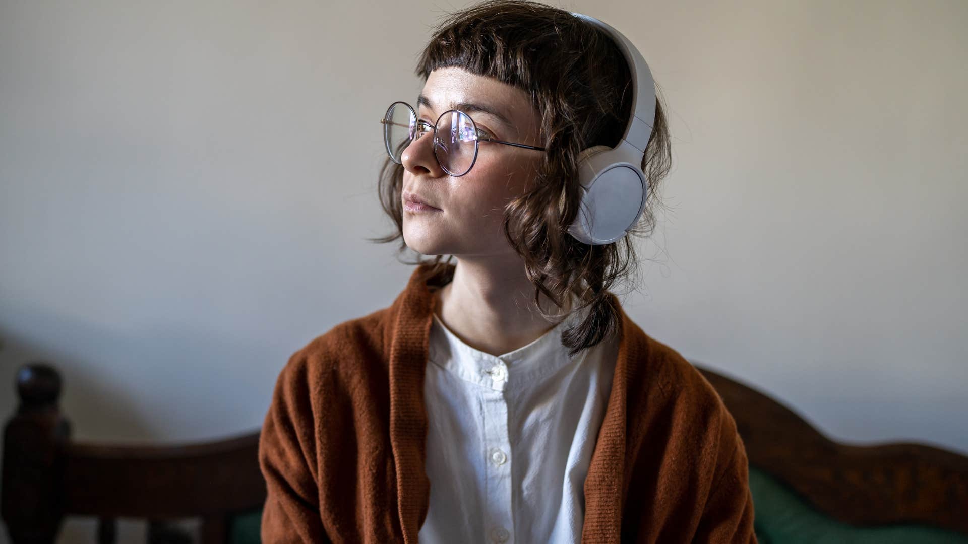intelligent woman listening to classical music with headphones on