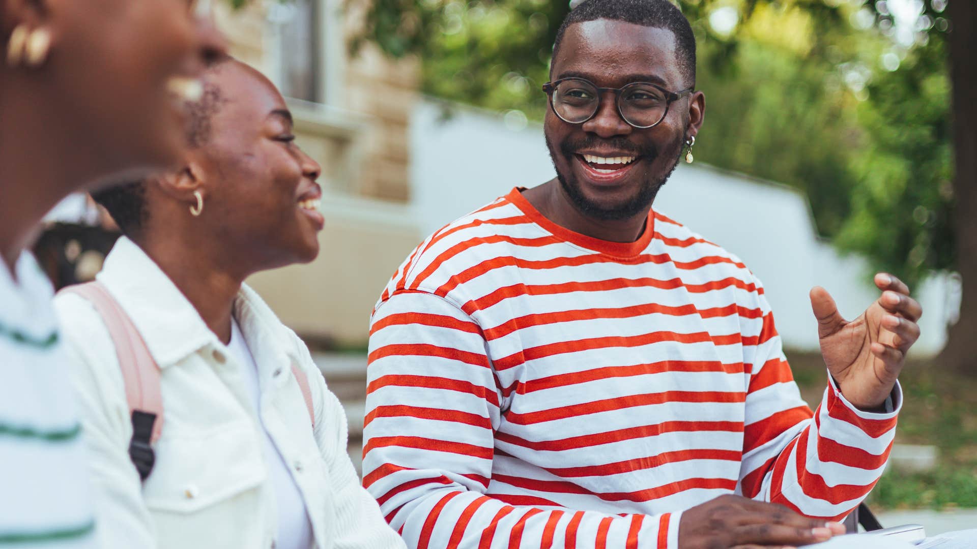 smart man smiling and learning from others around him
