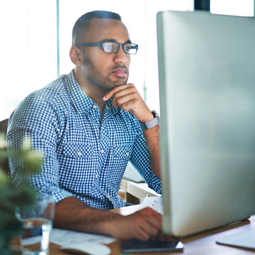 Man working on family desktop computers at home.
