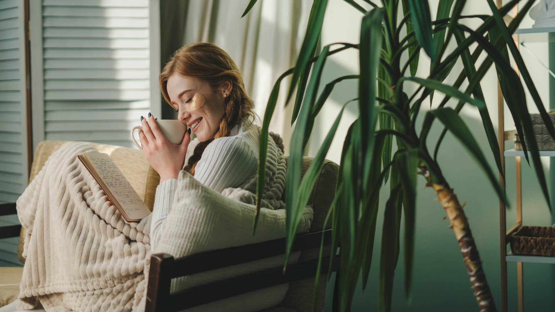 woman enjoying tea wrapped in a weighted blanket