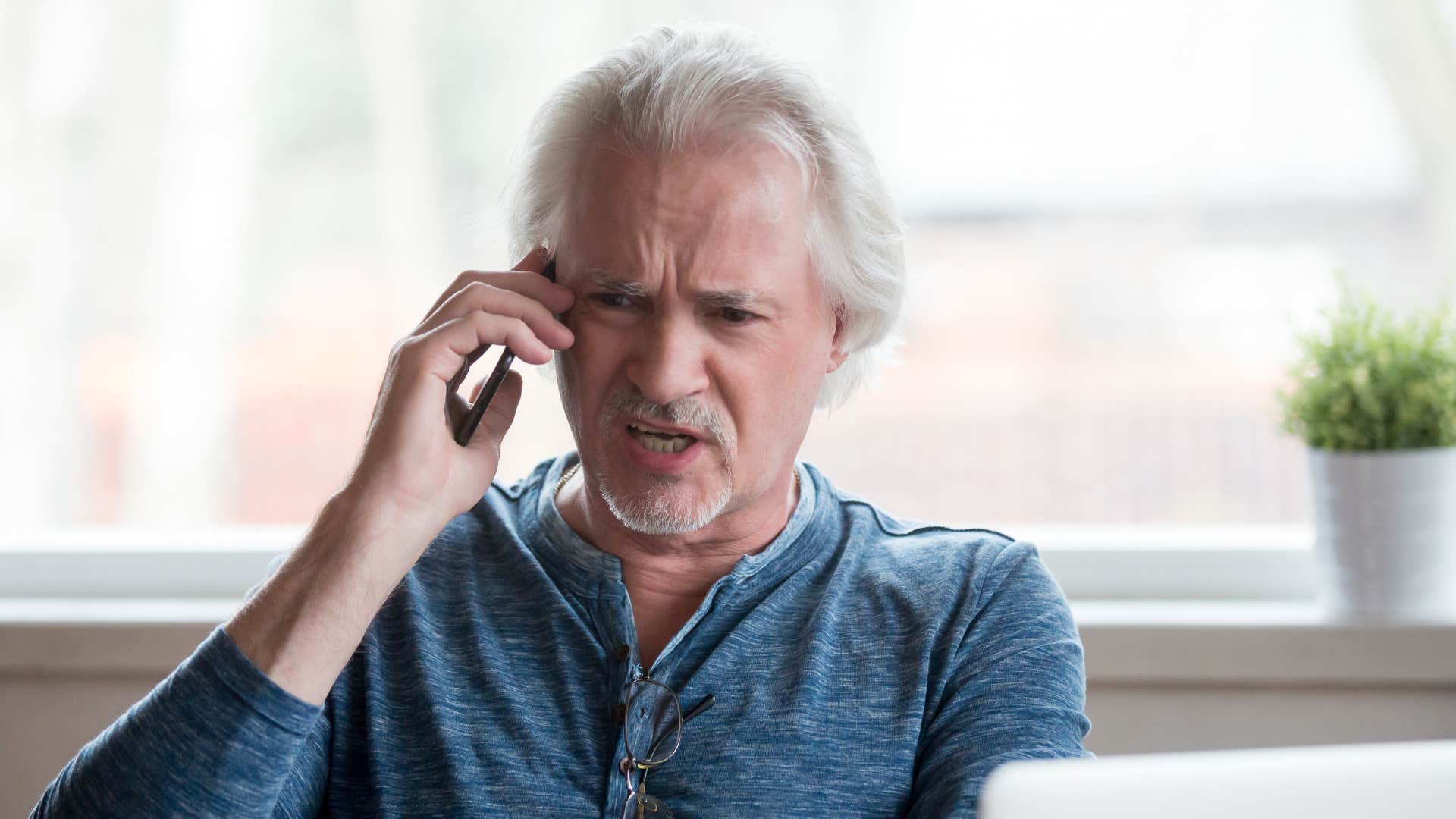 man with dark agenda talking on the phone