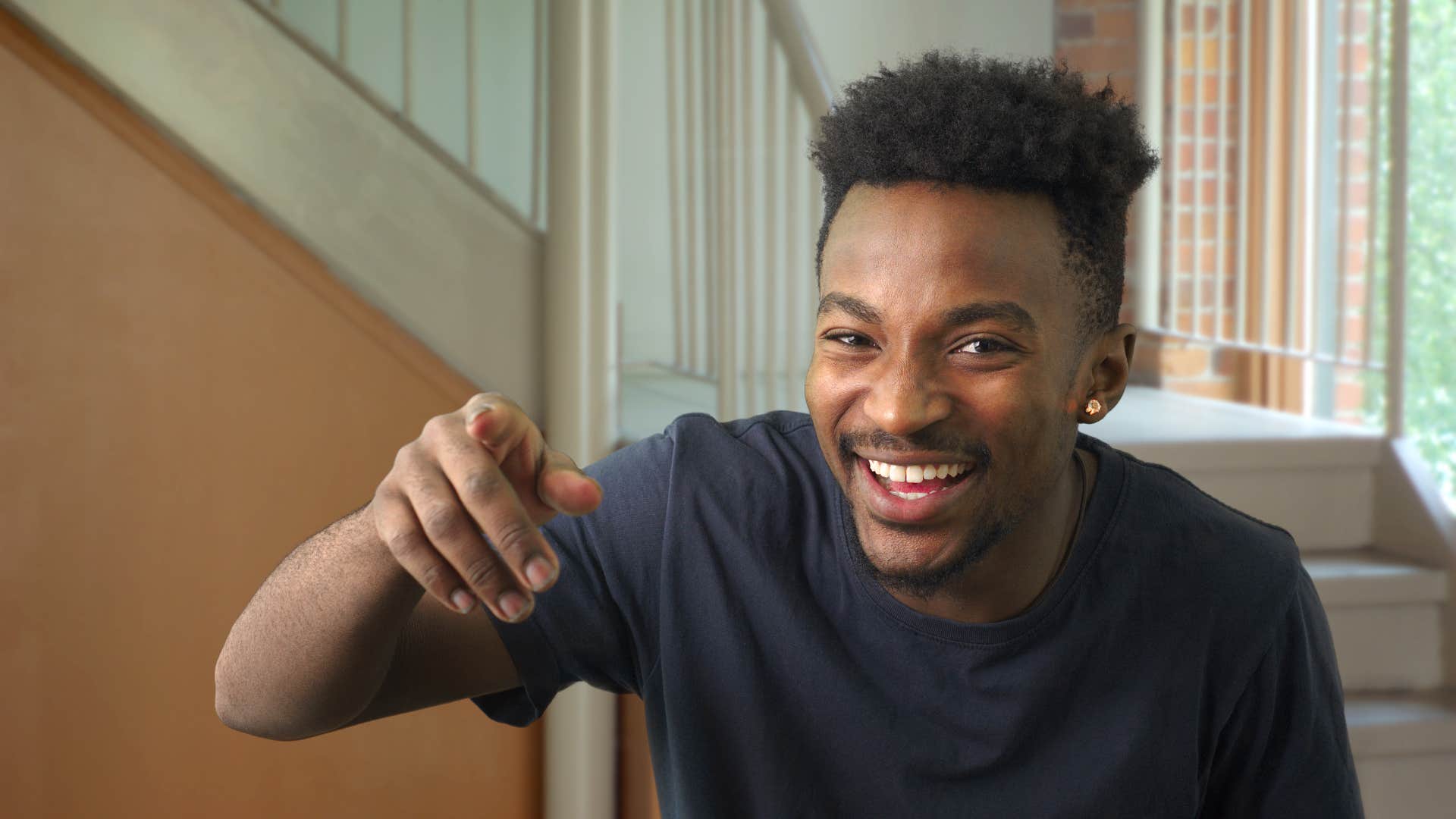 man laughing at friend pretending to test him