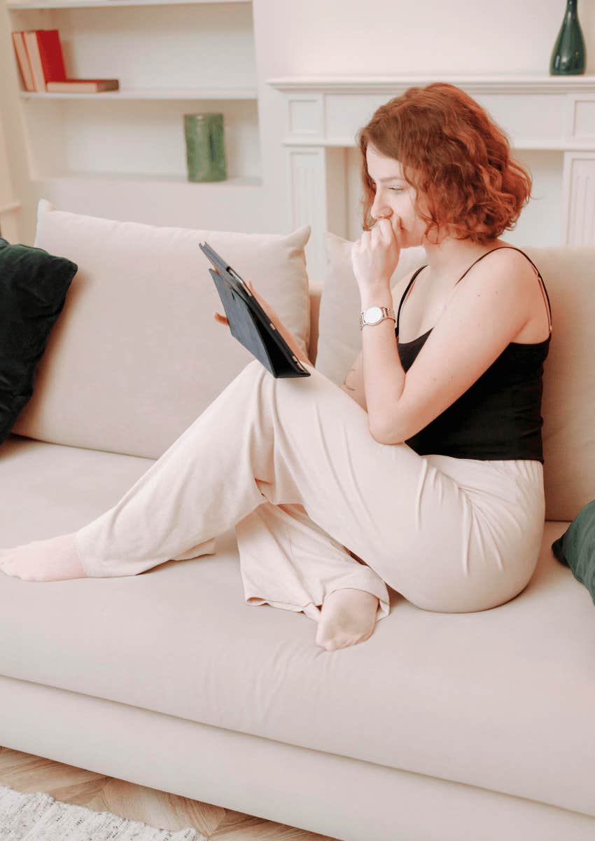 young woman spending alone time on her couch